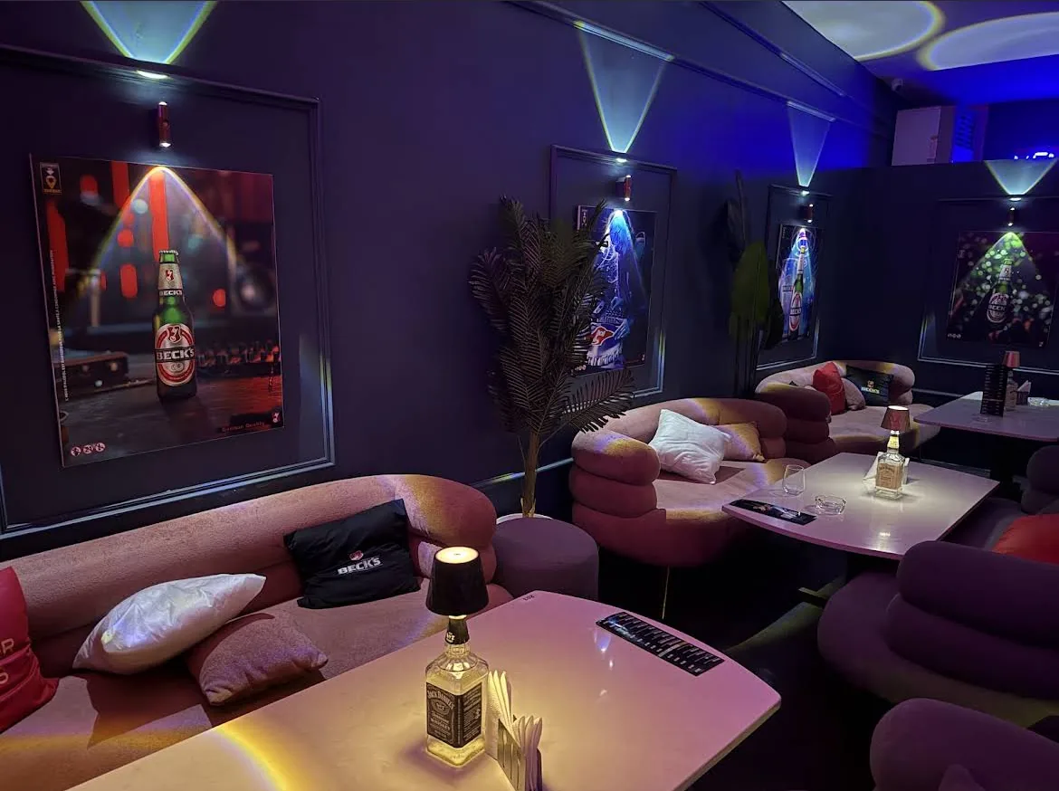 The indoor lounge at PianoPiano.dz, velvet banquettes and coloured light.